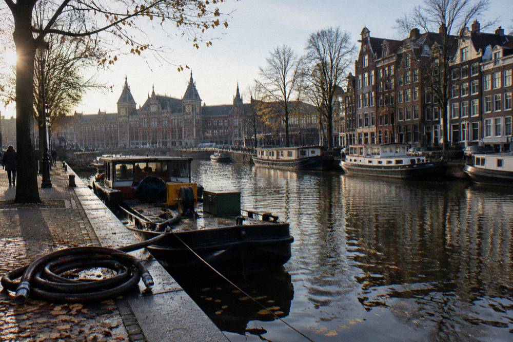 Autumn view along an Amsterdam canal with parked bicycles and bare trees