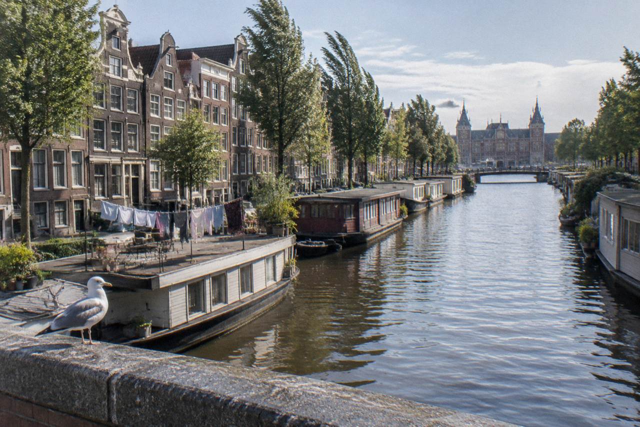 Canal houses and bridges in the centre of Amsterdam beside calm water
