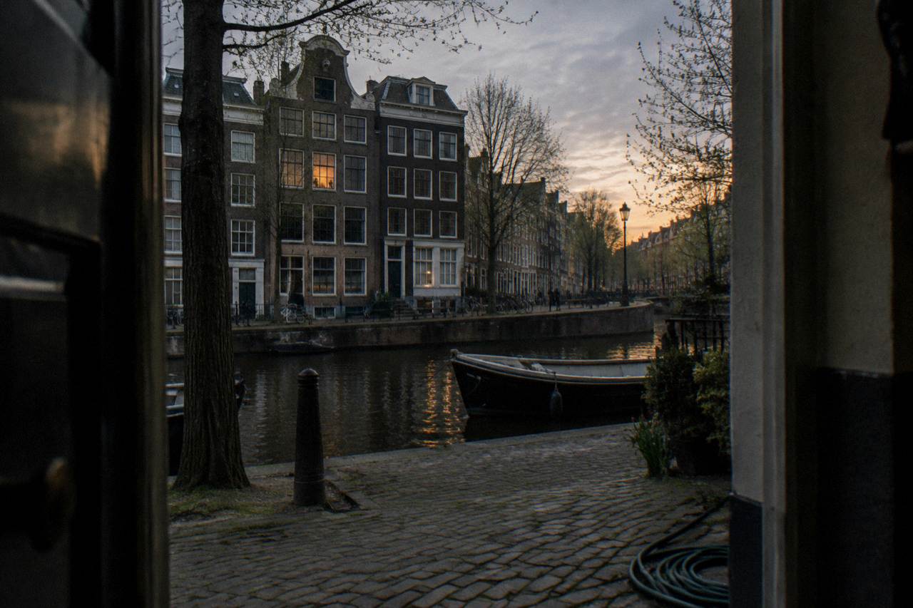 Canal houses and a quiet street in Amsterdam at dusk