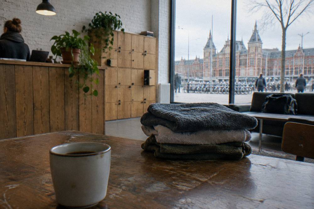 Reception desk and wooden lockers in a hostel common area